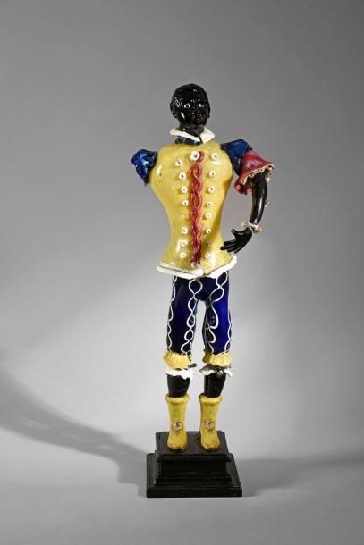 null Statuette en verre soufflé, et moulé d'un serviteur noir, dans son costume jaune...