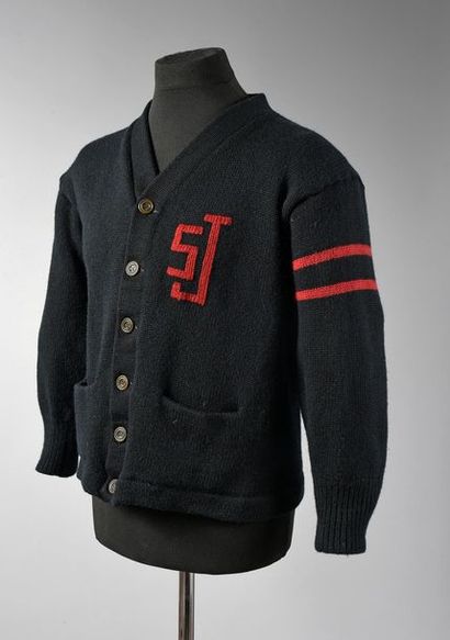 null HALLYDAY, JOHNNY 1 veste en laine de couleur noire, portant le sigle rouge SJ...