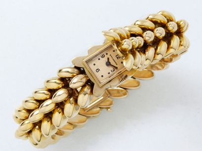 BOUCHERON Montre bracelet de dame en or 750 millièmes, cadran doré caché avec chiffres...