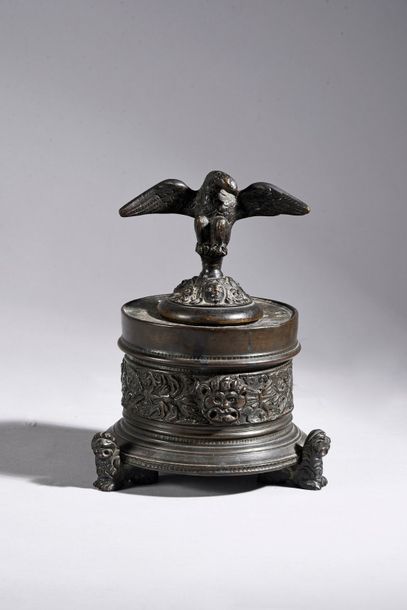 null An inkwell made of cast and engraved bronze, the round body with friezes of...