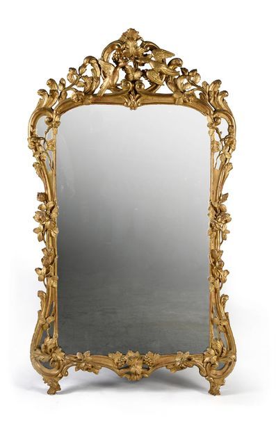 null Important wooden mirror richly carved, openworked and gilded with vine pamper...