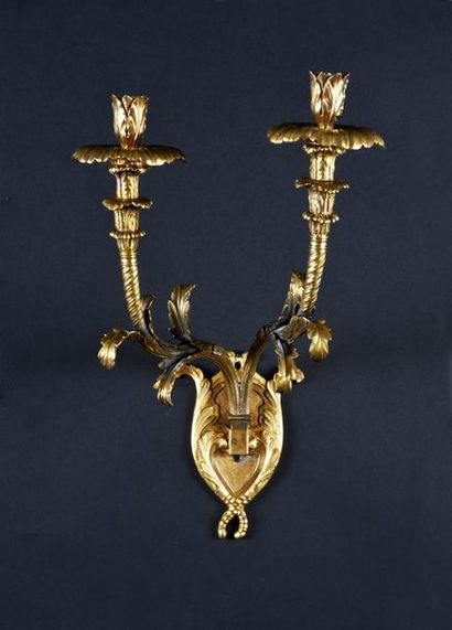 null Pair of wall lights with two arms of lights in chased and gilded bronze, decorated...