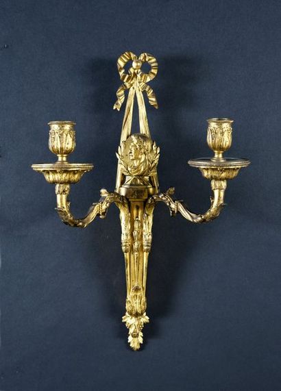 null Pair of gilded and engraved bronze wall lights with two arms of light decorated...