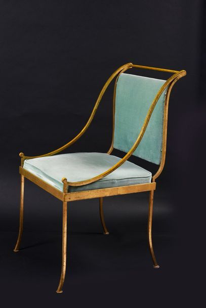 null Suite of four wrought and gilded iron armchairs, arched legs, overturned backrest,...