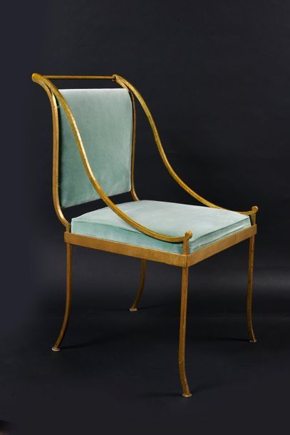 null Suite of four wrought and gilded iron armchairs, arched legs, overturned backrest,...