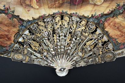 null A family evening, around 1900Grand fan folded, the leather leaf painted with...