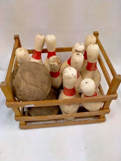 An antique bowling game in natural wood with...