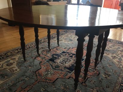 null 
A large mahogany table with six legs. Five extensions, two of which are in...