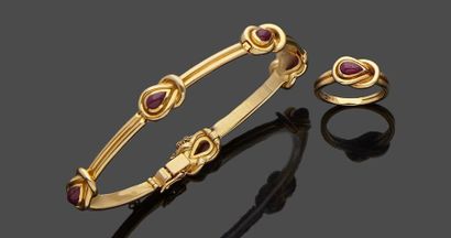 null 18k yellow gold set, 750‰, consisting of a ring set with a ruby cabochon cut...
