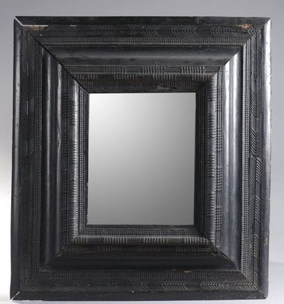 null MIRROR in a blackened wood blackened counter-profile frame decorated with guilloche...