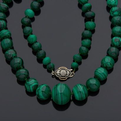 Necklace of malachite beads, falling, with...