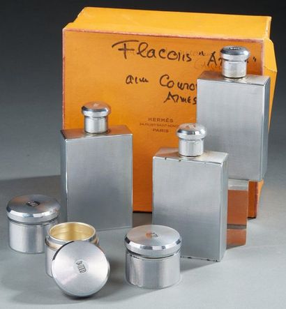 null HERMÈS 

Set of three bottles and three armoured boxes in silver, 1st title...