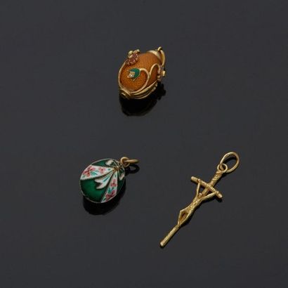 Two enamelled egg-shaped pendants, one in...