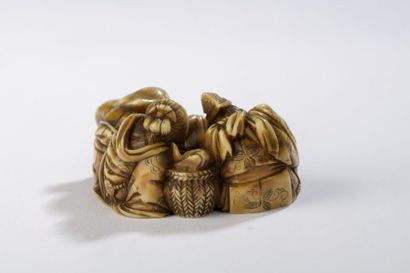 null Okimono en ivoire à patine jaune dans le style des netsuke, figurant Daikoku,...