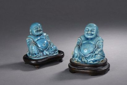 null TWO turquoise blue enamelled stoneware SUBJECTS depicting sitting budai. Wooden...