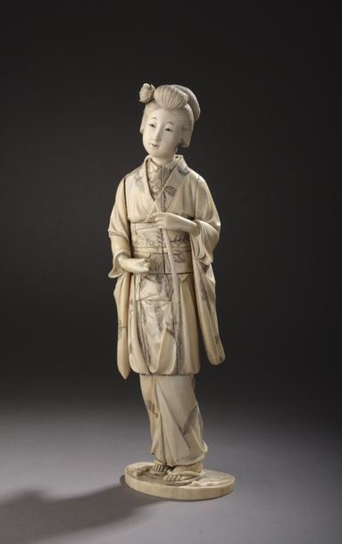 null OKIMONO in ivory carved and enhanced with ink, young woman standing on a terrace,...
