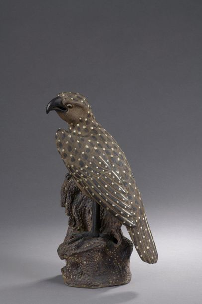 null SUBJECT in brown and cream glazed stoneware depicting a bird of prey perched...