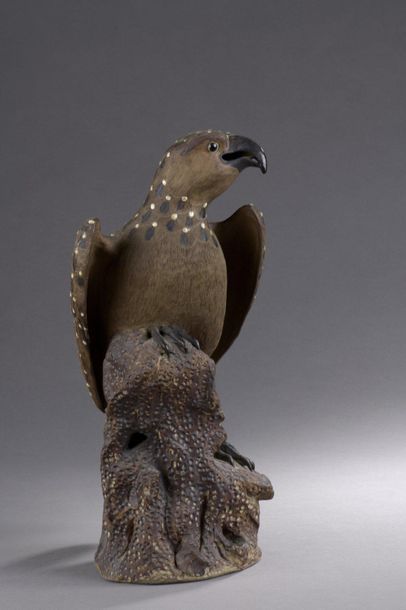 null SUBJECT in brown and cream glazed stoneware depicting a bird of prey perched...