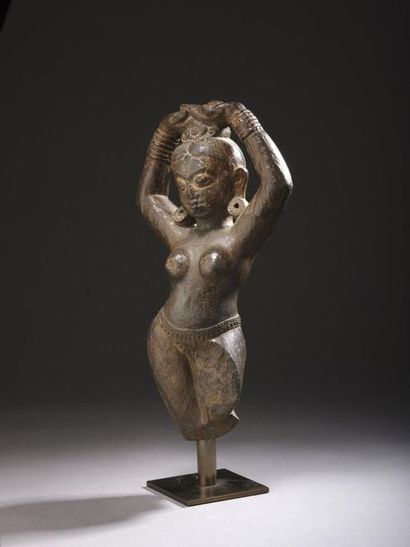 null STATUTE in dark stone depicting the river goddess Yamouna, the body in light...