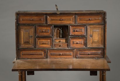 null Moulded walnut BARGUEÑO opening to a flap revealing twelve drawers and two doors...