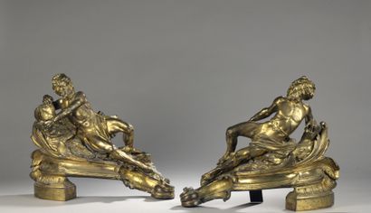 null A PAIR OF GOLDED BRONZE CHENETS decorated with a bearded figure lying on a rocky...