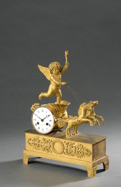 null PENDULET in gilt bronze representing a Love on his chariot, pulled by two horses....