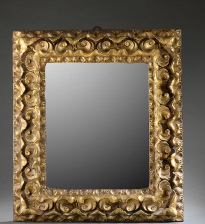 null MIRROR in a gilded wood frame richly carved with stylized foliage.

Italy, 17th...