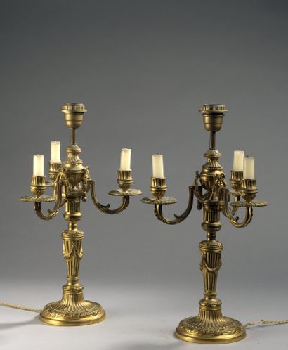 null PAIR OF Candelabra with three light arms in gilt bronze. Shaft and base with...