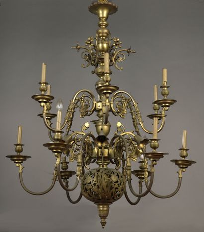 null IMPORTANT brass chandelier with twelve sinuous light arms in two rows around...