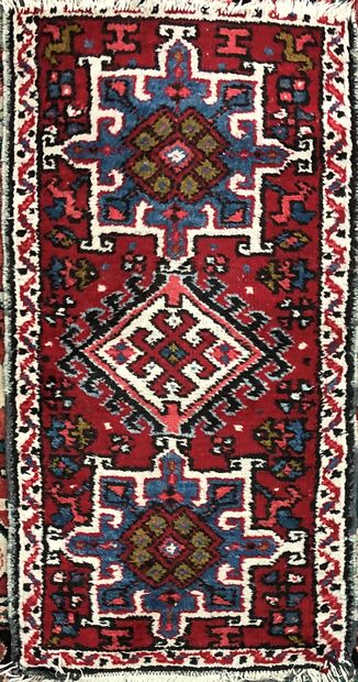  Set of four carpets (wear and tear) including : 
- Geometric blue and red floral...