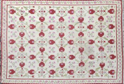  Kilim carpet decorated with stylised red flowers and green net of foliage on a cream...