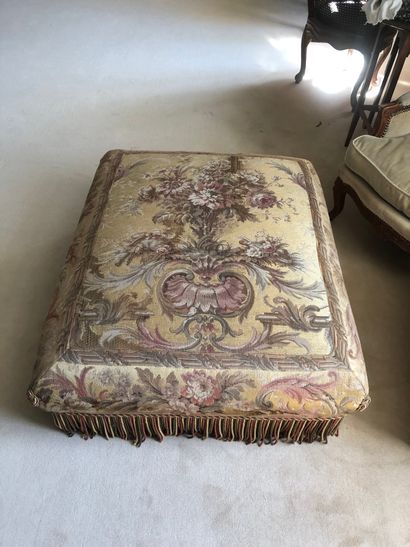 Rectangular pouffe with a decoration carpeted...