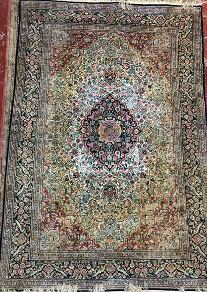  Two wool and silk carpets: 
- Hexagonal medallion with flowers on red background,...