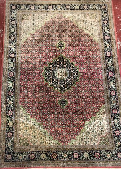  Two wool and silk carpets: 
- Hexagonal medallion with flowers on red background,...