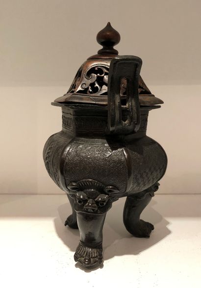 null Bronze tripod perfume burner with a brown patina, the body decorated with stylized...
