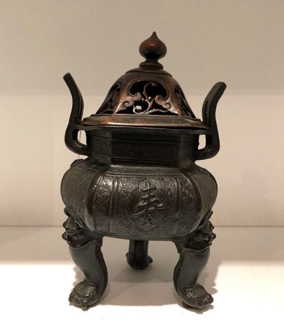 null Bronze tripod perfume burner with a brown patina, the body decorated with stylized...