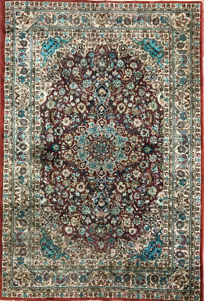  A set of six carpets (wear and tear) including : 
- Silk, red background with floral...