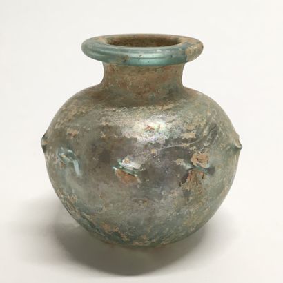 null Glass bottle of pan-shaped form with decoration of pinching on the shoulder.

Eastern...