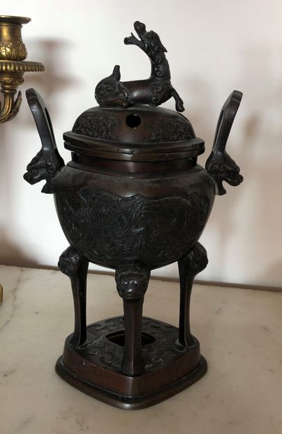 null CHINA

A patinated bronze four-legged incense burner with a dragon on the lid....