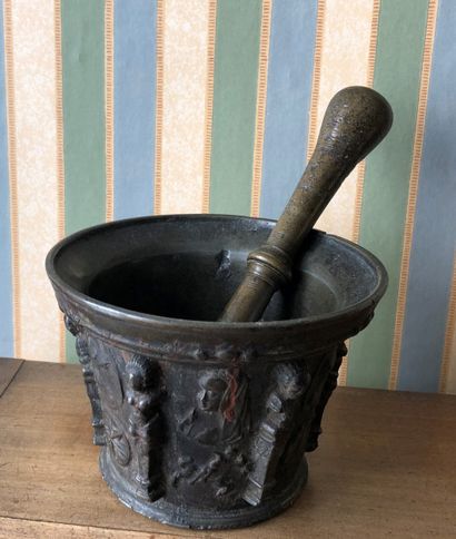 null Mortar and pestle in bronze with six alternating buttresses of flowered medallions...