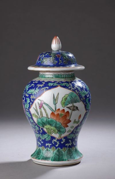 null A porcelain covered baluster vase decorated with reserves of birds and peonies...