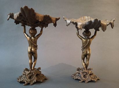 null A pair of bronze cups decorated with young men in the antique style. Rocaille...