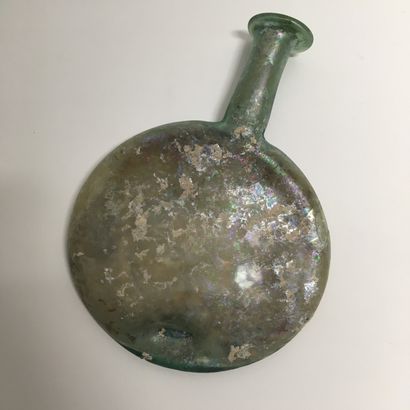 null Flat glass flask slightly green with orange and purple reflections.

Roman art.

Good...
