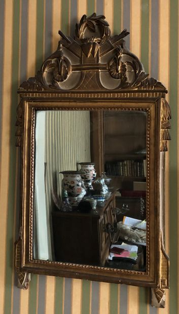 Gilded and carved wood mirror, foliage pediment,...