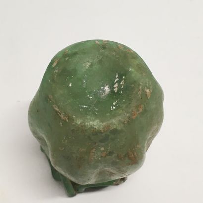 null A green glass aryball with a depressed body and a sawtooth-shaped net applied...