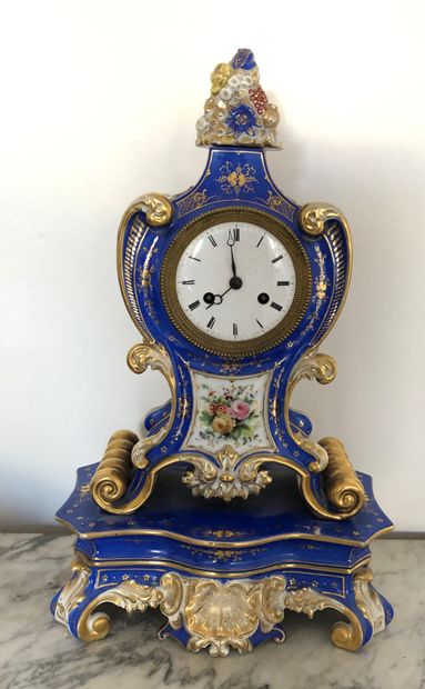 null A Louis XV style Paris porcelain clock and base with polychrome floral decoration...