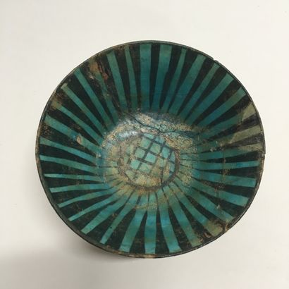 null A ceramic bowl of conical form on a small straight foot, glazed inside with...