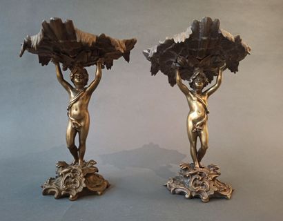 null A pair of bronze cups decorated with young men in the antique style. Rocaille...