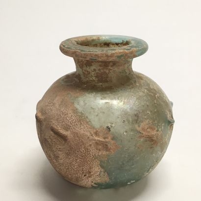 null Glass bottle of pan-shaped form with decoration of pinching on the shoulder.

Eastern...