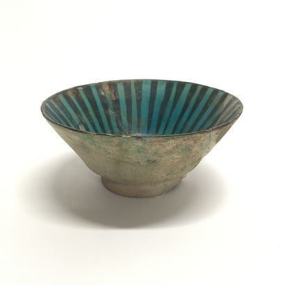 null A ceramic bowl of conical form on a small straight foot, glazed inside with...